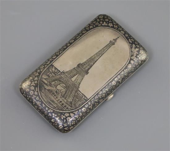 A late 19th century Russian 84 zolotnik silver and niello cigarette case, decorated with a view of the Eiffel Tower, gross 83 grams.